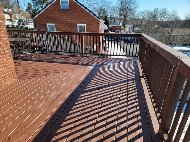 a view of deck with wooden floor and fence