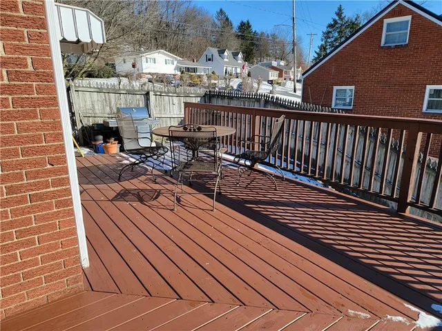 a view of a balcony with wooden floor