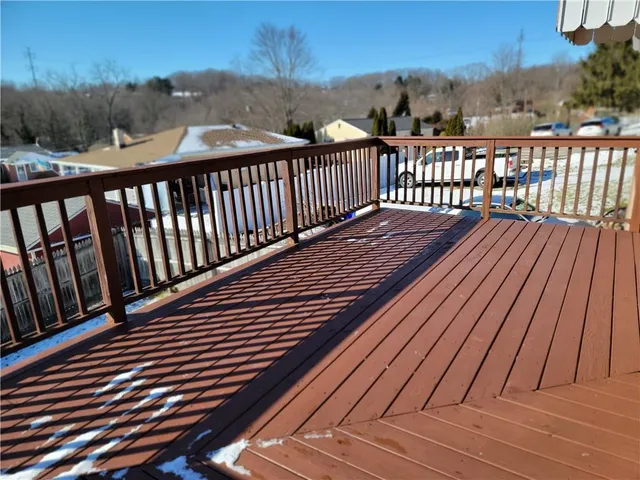 a view of balcony with wooden floor and fence
