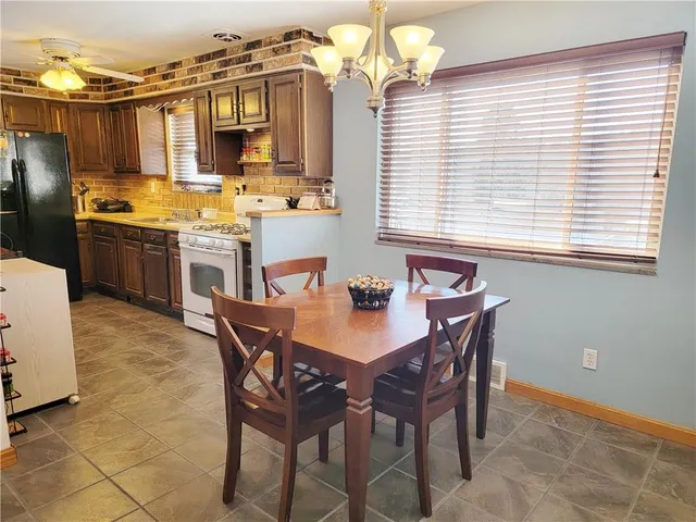 a view of a dining room with furniture and chandelier