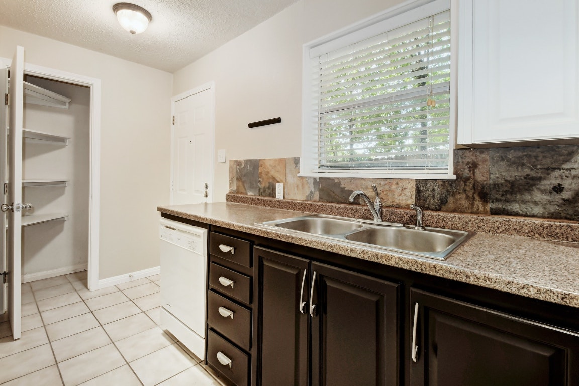 1704 East M. Franklin Avenue, Unit B Austin, TX 78721 - Photo 11 of 26 a kitchen with granite countertop a sink and a window