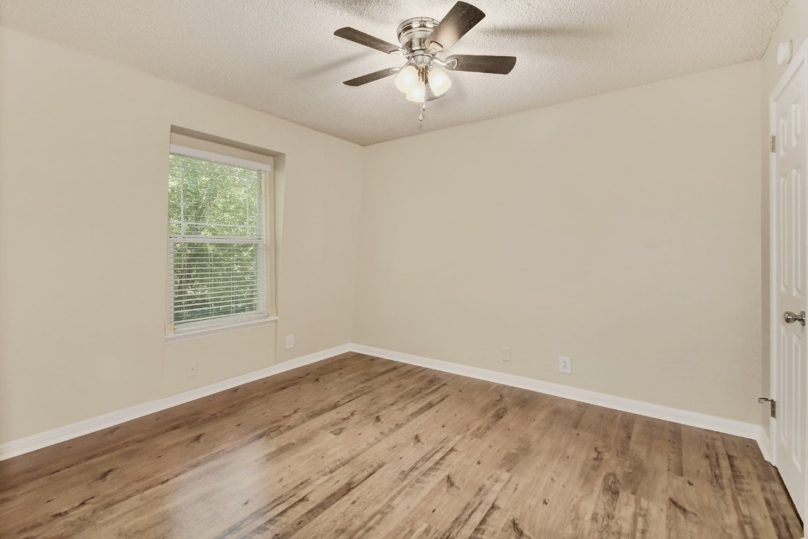 1704 East M. Franklin Avenue, Unit B Austin, TX 78721 - Photo 20 of 26 wooden floor in an empty room with a window