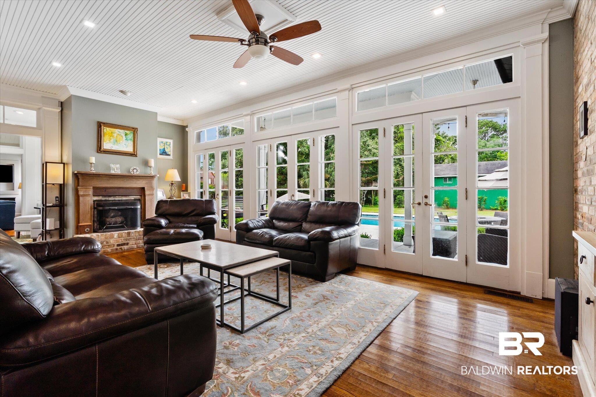 2205 Spring Hill Avenue Mobile, AL 36607 - Photo 19 of 59 Living room featuring a wealth of natural light, french doors, a brick fireplace, and hardwood / wood-style floors