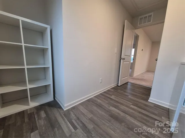 a view of a large white house in a field with large trees