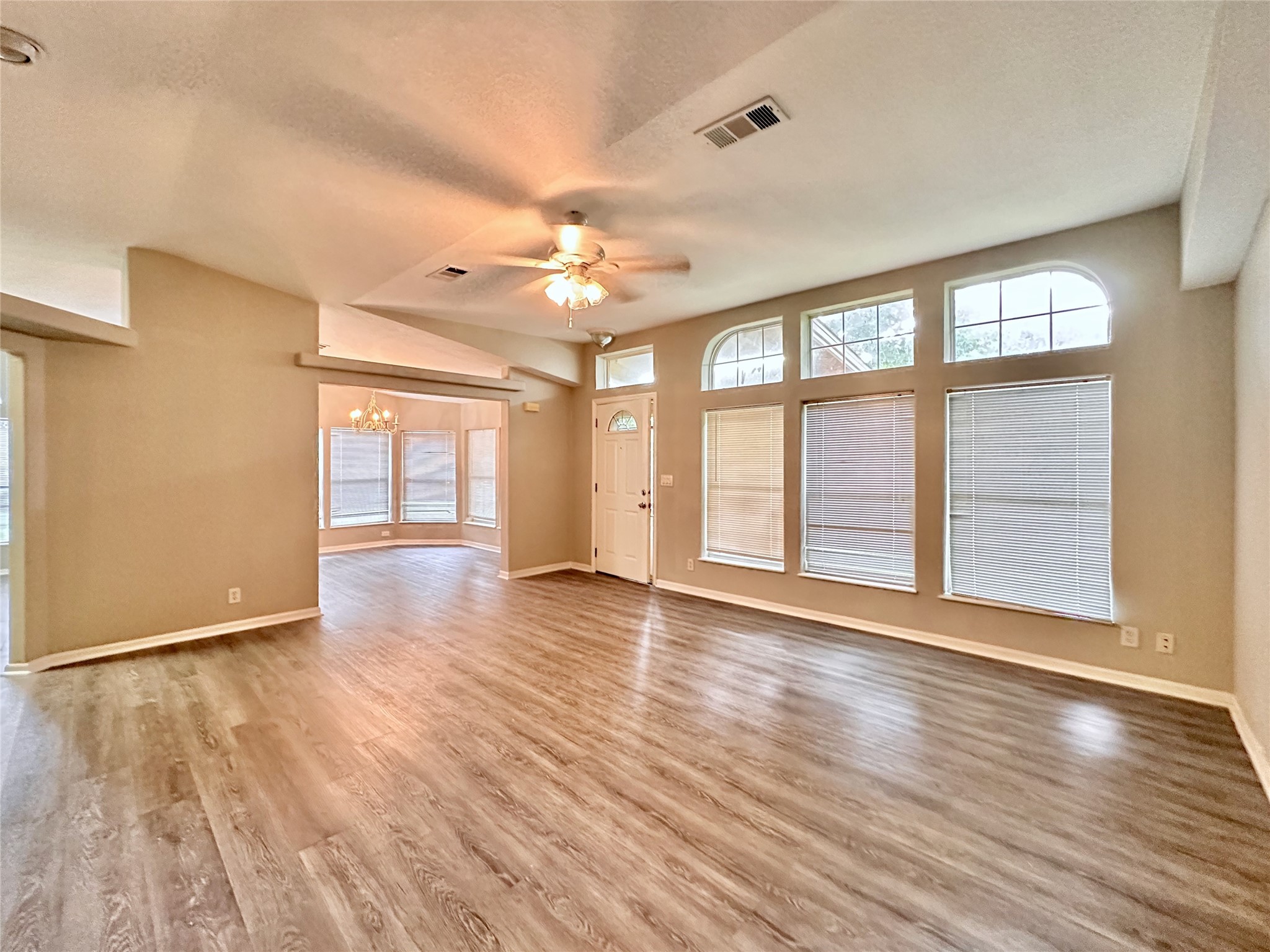 202 Main Street Fresno, TX 77545 - Photo 5 of 26 a view of an empty room with wooden floor and a window