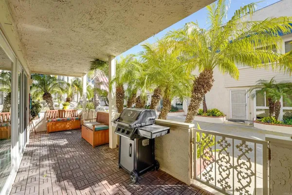 a view of a patio with swimming pool and sitting area