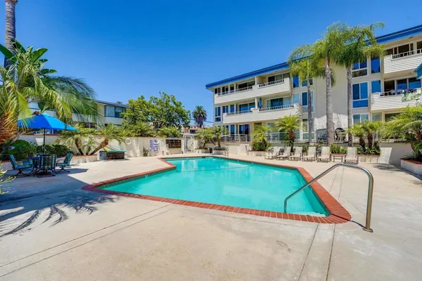 a swimming pool with outdoor seating and yard