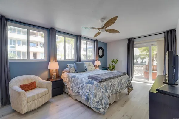 a bedroom with a bed couch and window