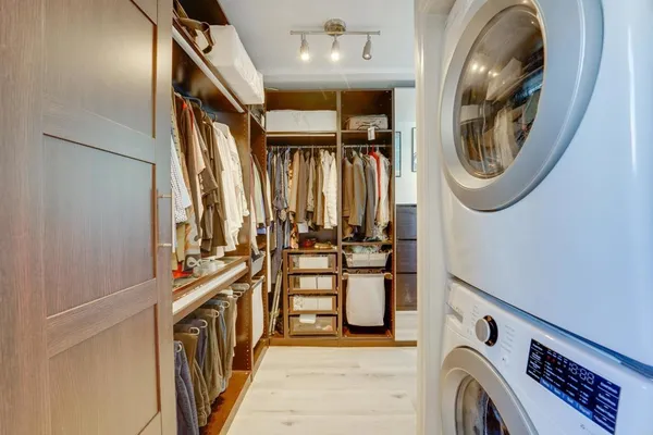 a view of a storage and utility room with washer and dryer