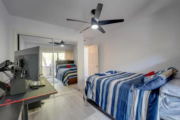 a bedroom with bed and a tv