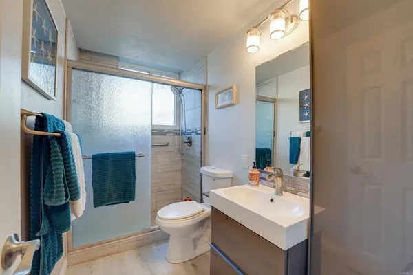 a bathroom with a sink toilet and shower