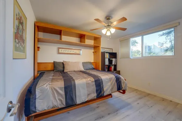 a bedroom with a large bed and a chandelier