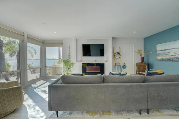 a living room with furniture a large window and a fireplace