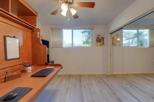 a view of a room with wooden floor and chandelier