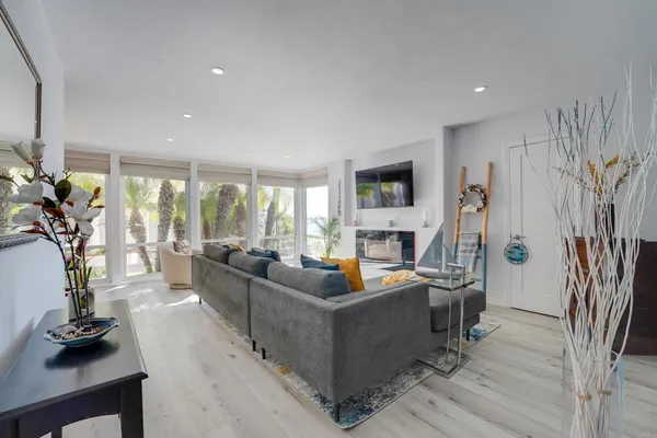 a living room with furniture a large window and a flat screen tv