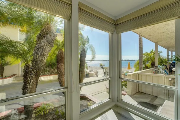 a room with a large window and an outdoor shower