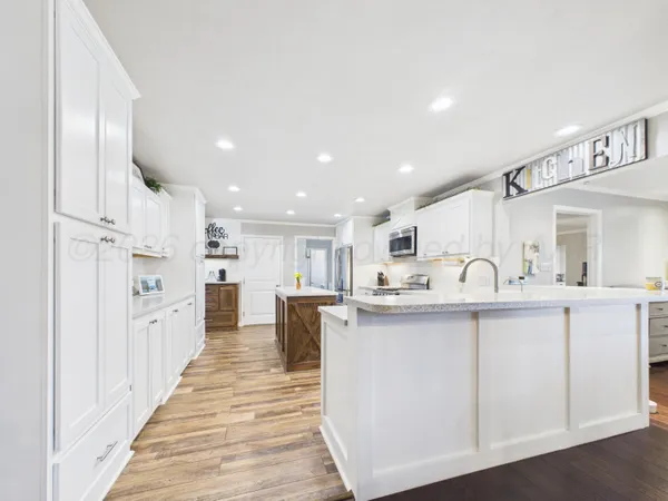 a kitchen with kitchen island granite countertop a sink and counter top space