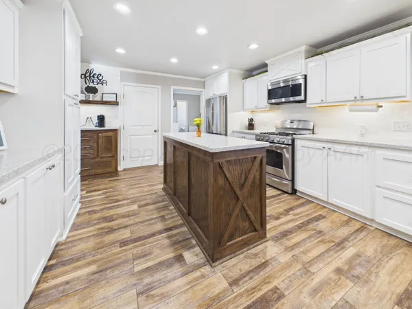 a stove top oven sitting inside of a kitchen