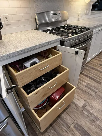 a kitchen with stainless steel appliances white cabinets and a sink