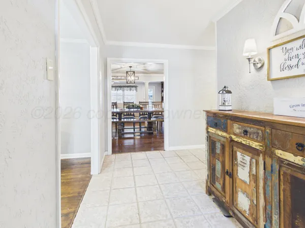 a view of a hallway with wooden floor and furniture
