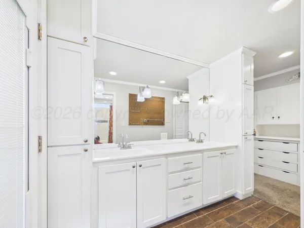 a bathroom with a sink a large mirror and a shower