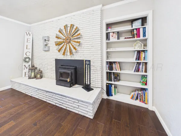 a living room with fireplace furniture and a wooden floor