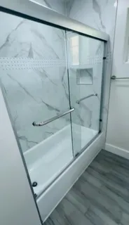 a bathroom with a glass shower door