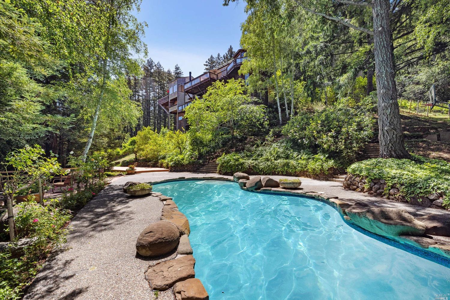 a view of a backyard with swimming pool