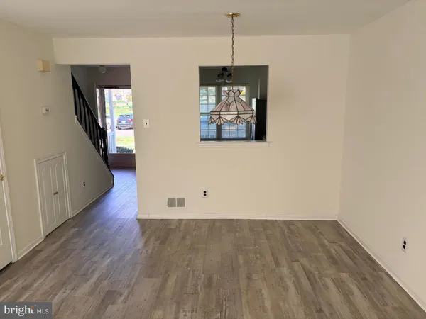 a view of a livingroom with wooden floor and a fireplace