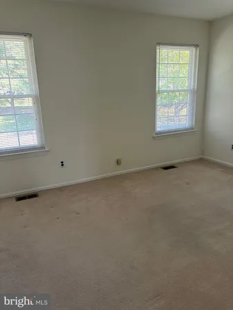 a view of a livingroom with wooden floor and a fireplace