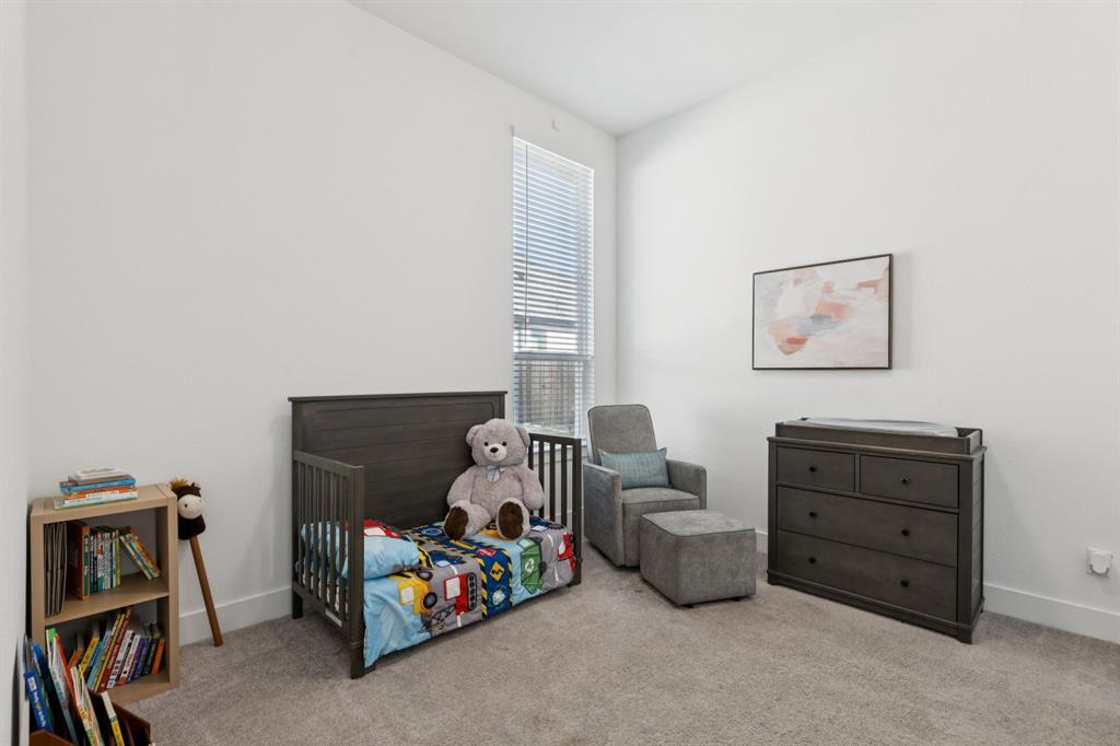 1903 Midhurst Drive Forney, TX 75126 - Photo 20 of 31 a bedroom with a baby bed chair and a window