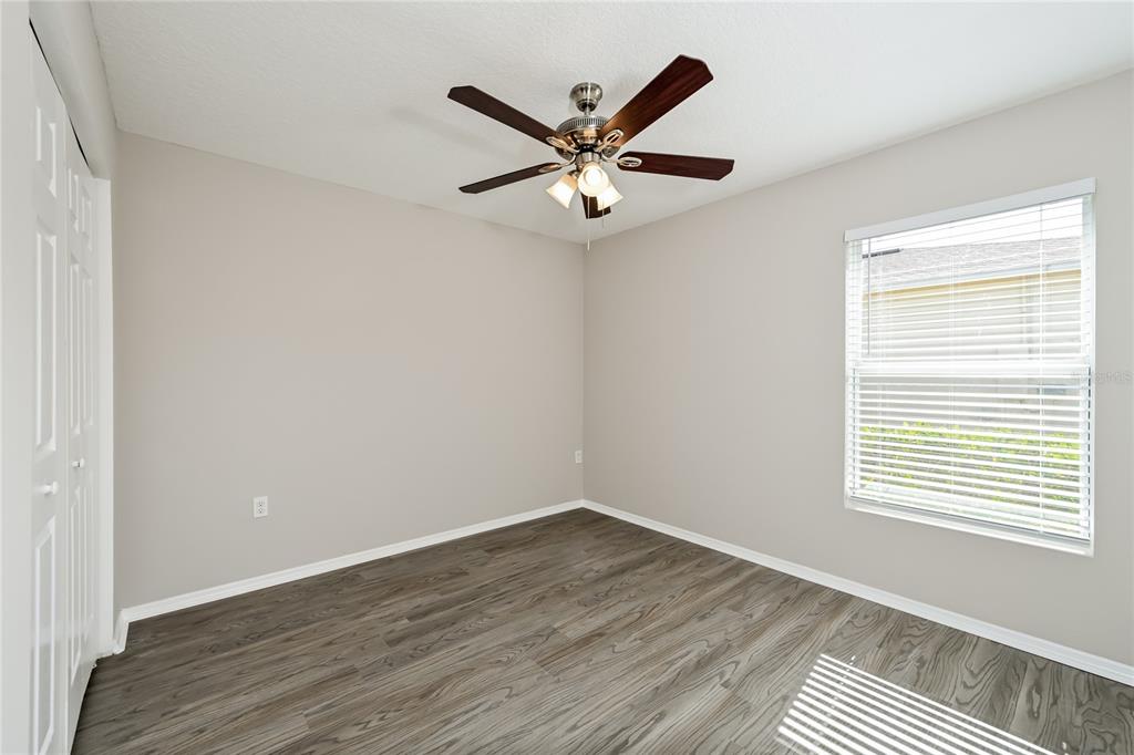 149 Springberry Court Daytona Beach, FL 32124 - Photo 12 of 16 an a view of an empty room with wooden floor and a window