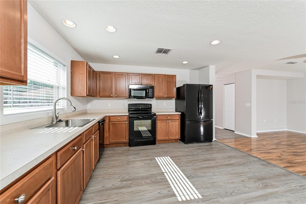 149 Springberry Court Daytona Beach, FL 32124 - Photo 4 of 16 a kitchen with stainless steel appliances granite countertop a refrigerator sink and cabinets