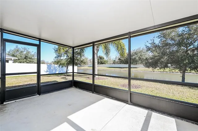 a view of an empty room with large windows