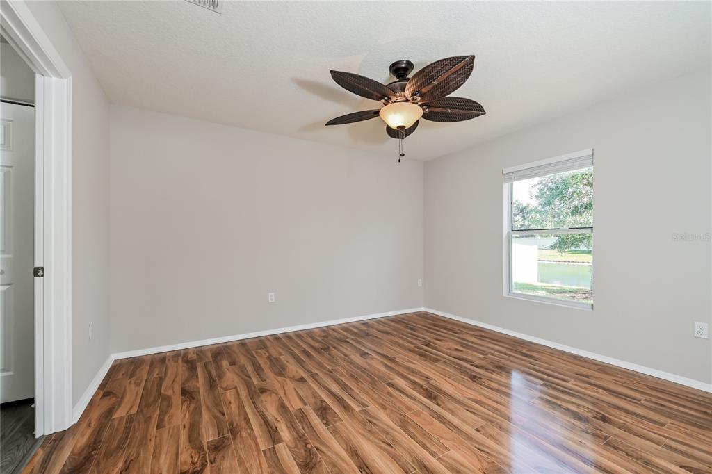 149 Springberry Court Daytona Beach, FL 32124 - Photo 8 of 16 a view of a room with wooden floor and fan