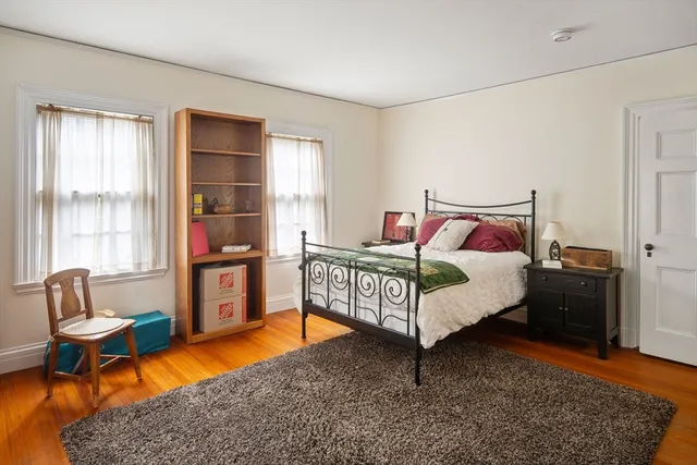 a bed room with a bed and a chair