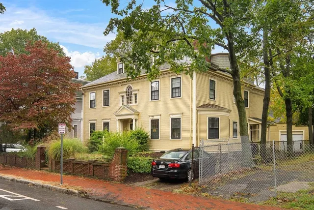 a car parked in front of a white house