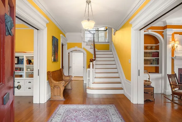 a view of entryway and hall with wooden floor