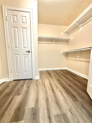 a view of a room with wooden floor