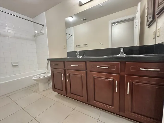 a bath room with sink and a toilet