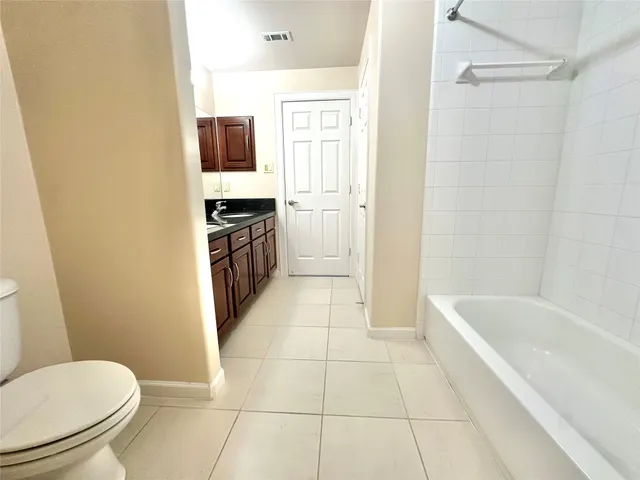 a bathroom with a toilet a sink and bathtub