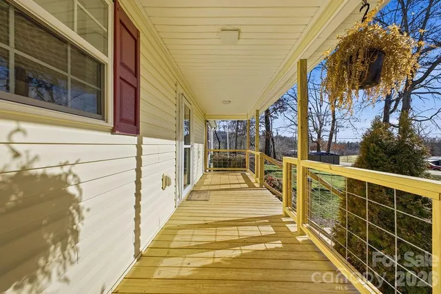 a view of balcony with wooden floor and outdoor seating