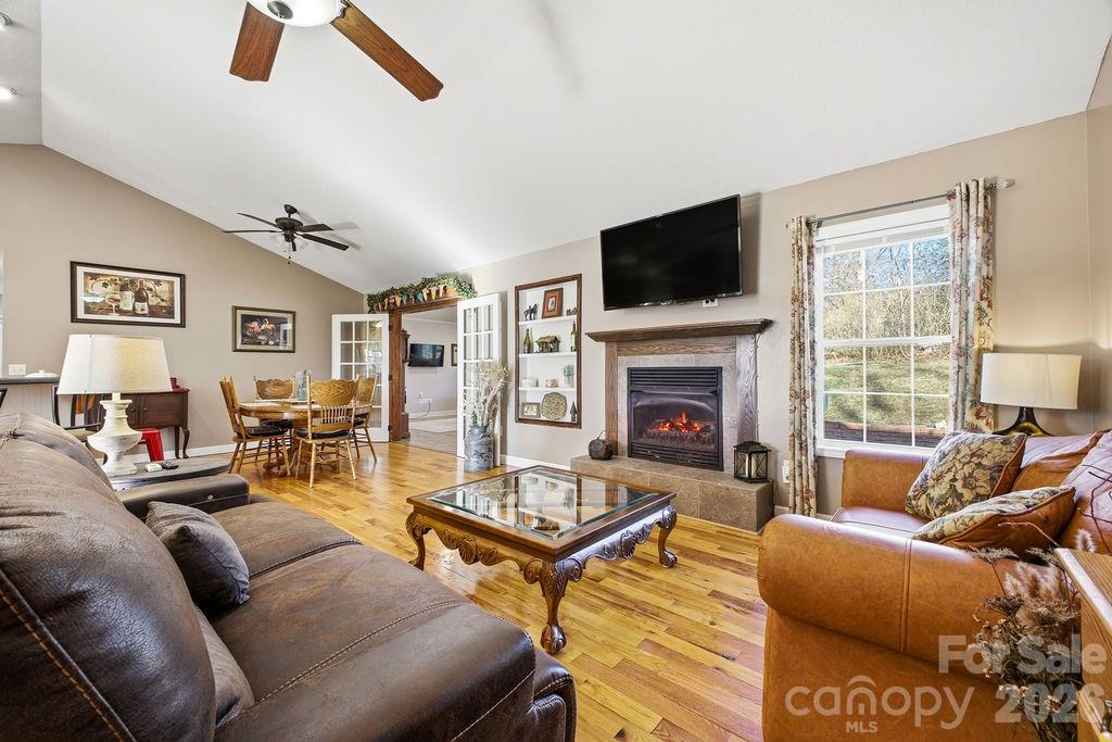 1113 Brookside Camp Road Hendersonville, NC 28792 - Photo 4 of 20 a living room with furniture a flat screen tv and a fireplace