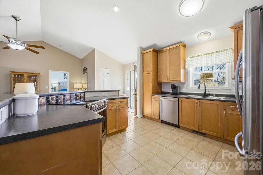 1113 Brookside Camp Road Hendersonville, NC 28792 - Photo 6 of 20 a kitchen with stainless steel appliances granite countertop a sink a stove and refrigerator
