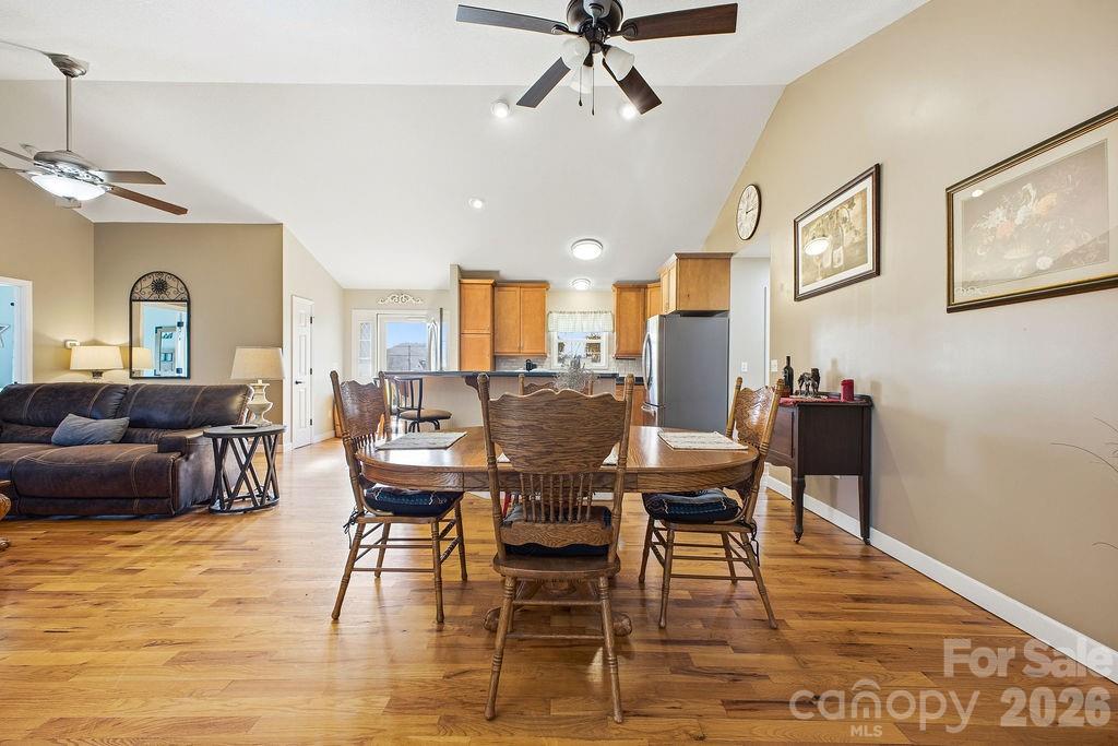 1113 Brookside Camp Road Hendersonville, NC 28792 - Photo 7 of 20 a view of a dining room with furniture and wooden floor