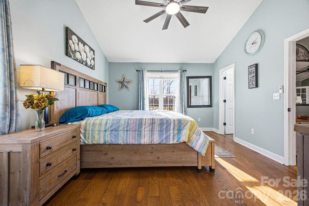 1113 Brookside Camp Road Hendersonville, NC 28792 - Photo 10 of 20 a bedroom with a bed and a chandelier