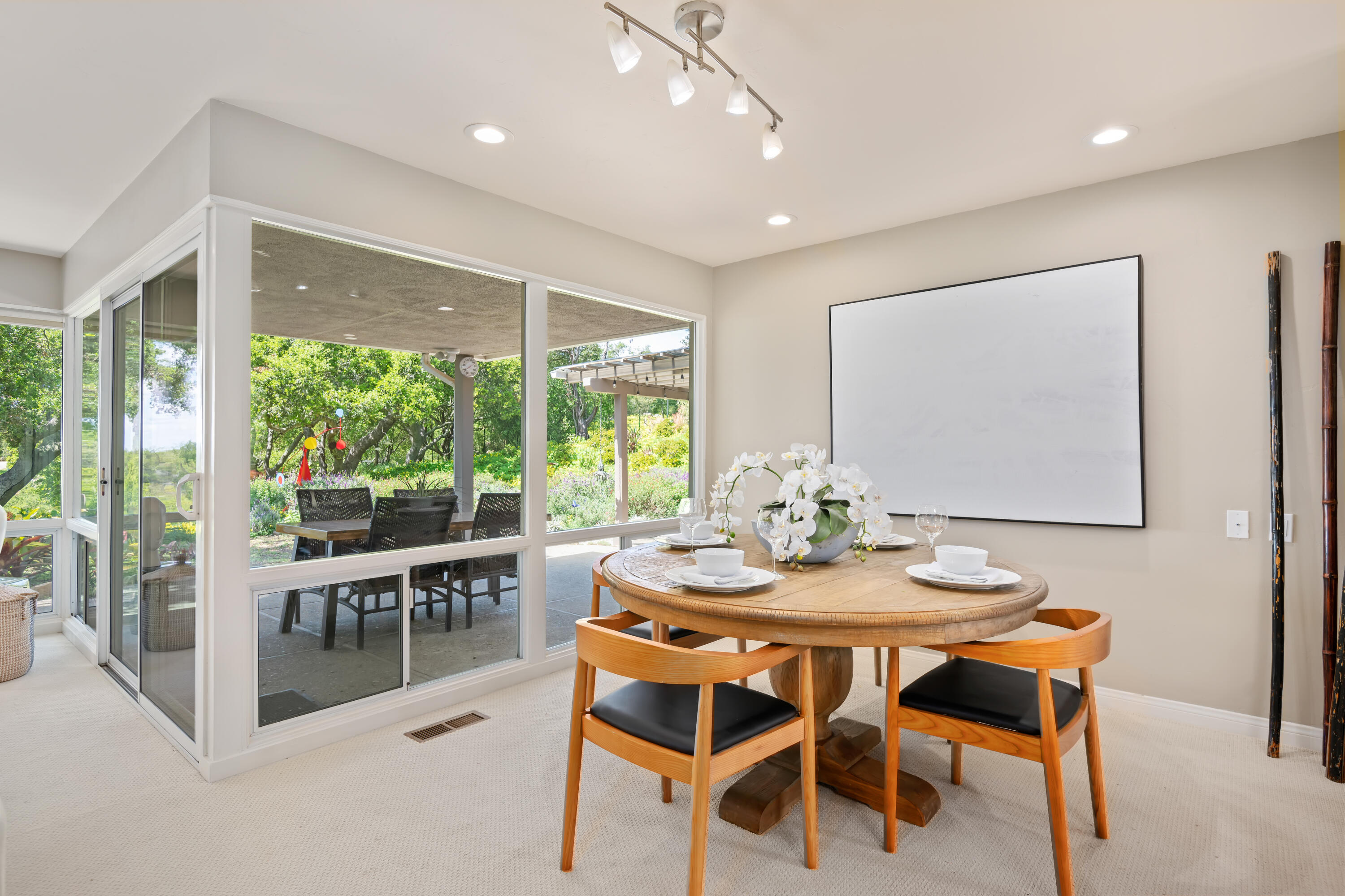599 Mountain Drive Santa Barbara, CA 93103 - Photo 4 of 11 a dining room with furniture large windows and a chandelier