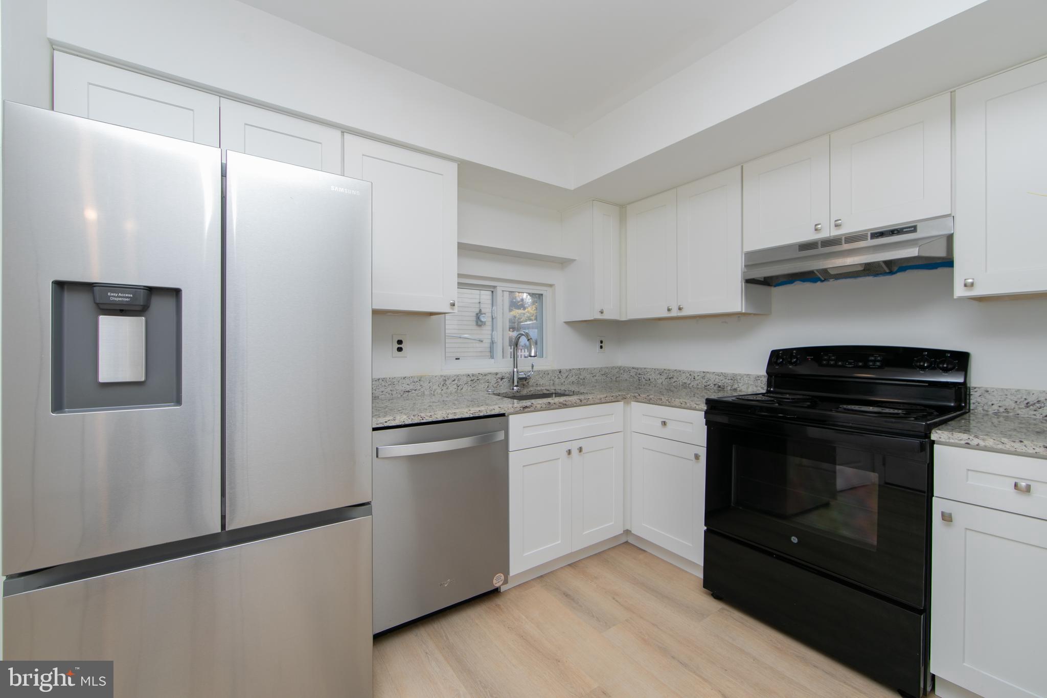 1042 Central Avenue Runnemede, NJ 08078 - Photo 11 of 36 a kitchen with stainless steel appliances granite countertop a stove a refrigerator and a sink