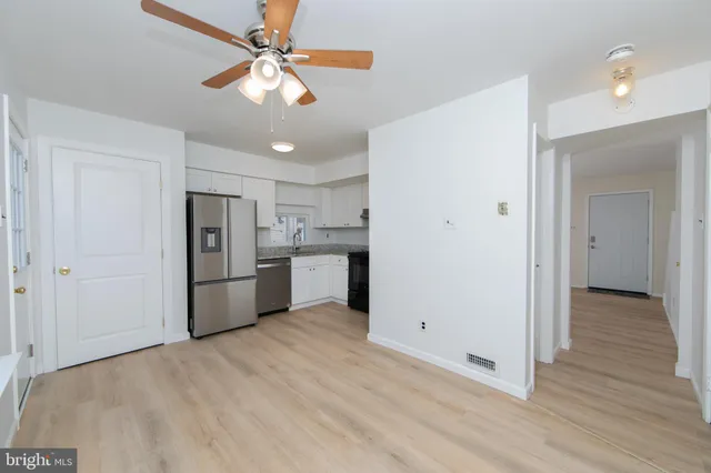 a view of a kitchen with a sink and a refrigerator