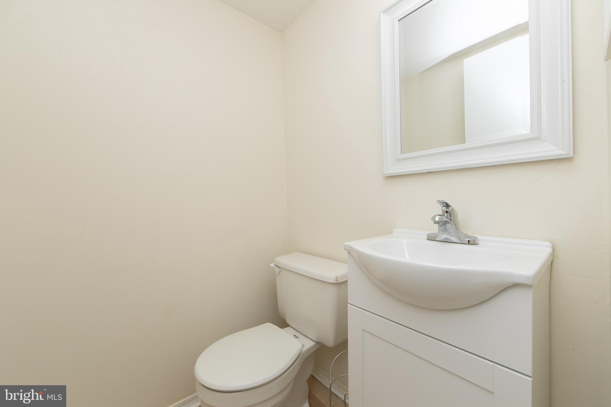 1042 Central Avenue Runnemede, NJ 08078 - Photo 15 of 36 a bathroom with a sink a toilet and mirror